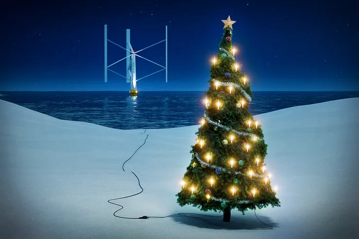 Julillustration: en tänd julgran i snön vid vattenbrynet, med en kabel som löper ut i havet till ett flytande vertikalaxlat vindkraftverk