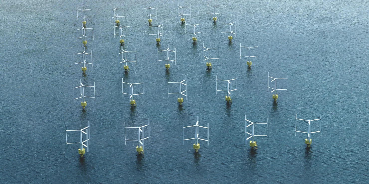 Vindkraftpark med vertikalaxlade verk i formation på havet, sedd snett uppifrån